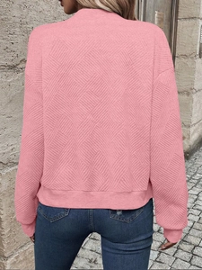 Rear view of pink textured jacket showcasing the detailed waffle knit pattern on fabric