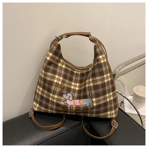 Detail of vintage brown plaid bag featuring a cute dachshund embroidery on canvas