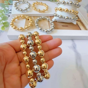 Gold and silver 6mm and 10mm beaded stretch bracelets set for a stylish layered look