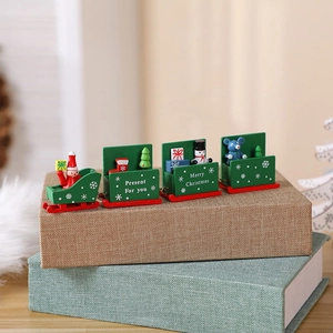 Detail of wooden Christmas train decor with Santa and snowman figures on gift books