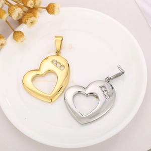Gold and silver heart necklaces with crystals on a white plate with dried flowers
