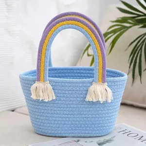 Detailed macro view of light blue woven cotton bag with rainbow handle and tassel decoration