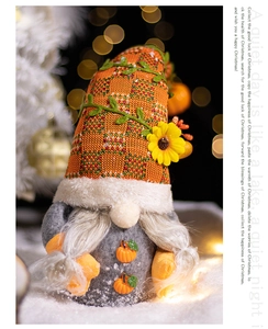Detailed view of an autumn gnome with orange knitted hat in a snowy Christmas scene