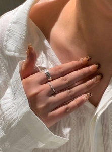 Detail of silver plated 18k gold hammered texture open ring and thin band on hand