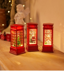 Detailed view of red telephone booth Christmas lanterns with Santa and snowman scenes