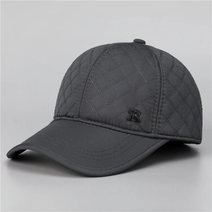 Detail of grey diamond-quilted baseball cap with metallic R logo and ear protection