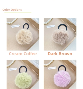 Detail of plush pom pom hair ties in cream, brown, green and purple with elastic bands