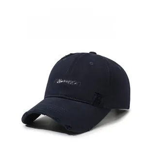 Detailed shot of dark blue baseball cap with white Narason embroidery and distressed holes