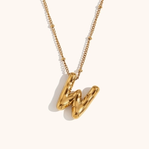 Detailed close-up of 18K gold plated 3D bubble letter W pendant necklace on bead chain