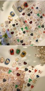 Detail of vintage nail art stickers featuring surrealist moon, heart, and clock patterns