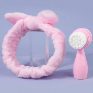 Pink cat paw facial cleansing brush set with soft plush bunny ear headband on purple background