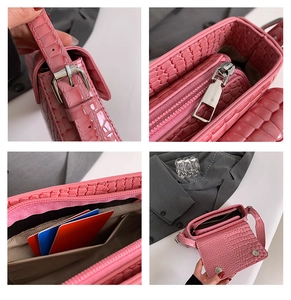 Detail view of pink crocodile pattern handbag showing strap, zipper and interior card slots