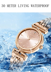 Close-up of rose gold waterproof watch submerged in dynamic blue water splashes