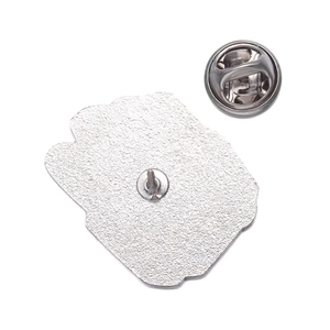 Detail view of the silver metal pin back featuring a textured finish and butterfly clasp