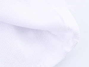 Detailed close-up of the white textured grid fabric with professional overlock edge stitching