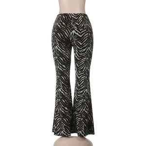 Detail view of tiger print flared trousers with high-waisted cut and animal pattern design