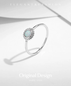 Detailed macro view of an s925 silver sunflower ring with a round white opal stone