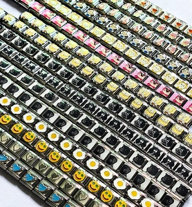 Detailed view of Italian charm bracelet links featuring colorful enamel character designs