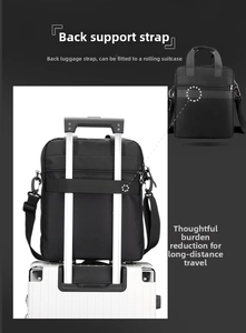 Detail of black business bag with a luggage strap securely attached to a suitcase handle