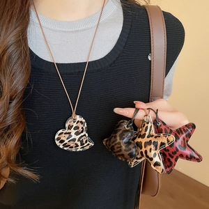 Close-up of leopard print heart and star pendants on a retro ethnic style necklace