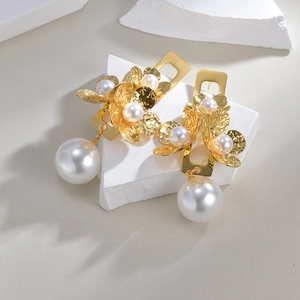 French vintage style gold flower and large pearl earrings set on white stone