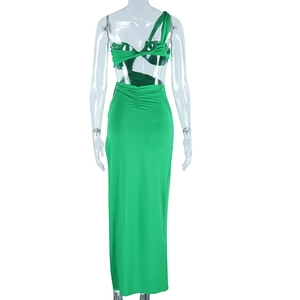 Detail of back cutout and ruched waist on a green one-shoulder evening gown