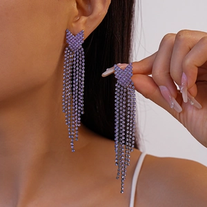 Close-up of elegant purple rhinestone tassel earrings with V-shape geometric design