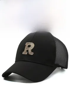 Detail view of the embroidered letter R on a black mesh baseball cap with curved brim