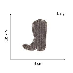 Detailed view of a brown cowboy boot embroidery patch measuring 6.7cm by 5cm for apparel