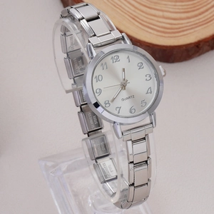 Detail view of silver quartz watch with stainless steel strap and Arabic numeral dial