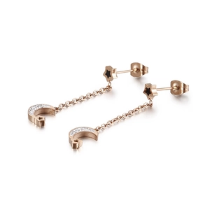 Elegant rose gold star and moon drop earrings with sparkling rhinestones on white base