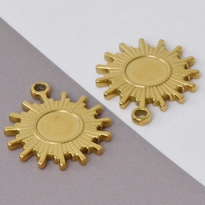 Macro detail of two golden 304 stainless steel sun-shaped pendant charms with high texture