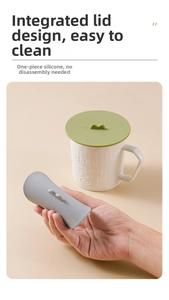 Detailed view of sage green and grey silicone cup covers with easy-grip handles