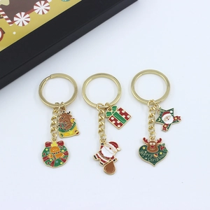 Three-piece gold metal Christmas keychains with Santa Claus, reindeer and wreath charms