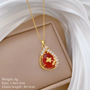 Detail view of gold necklace with red teardrop gemstone and 40+5cm chain specifications
