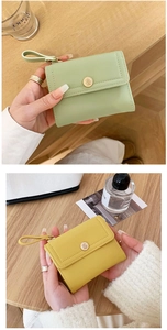 Detail of short tri-fold wallet with golden rose hardware buckle and wrist strap