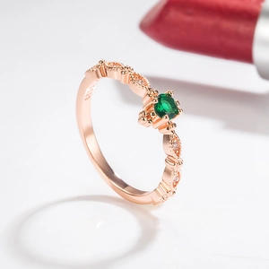 Elegant 14k rose gold ring with a round emerald center stone and small side diamonds