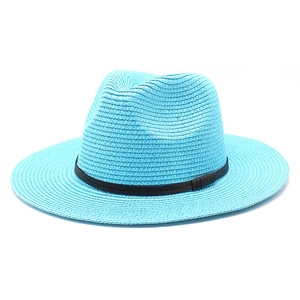 Detail of light blue straw fedora hat featuring compact weave and dark accent band