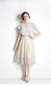 Detailed view of light yellow floral lace dress with blue hollowed-out ribbon trim