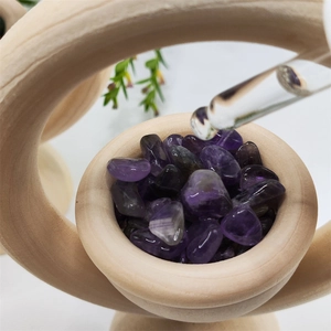 Vertical wooden aromatherapy diffuser with purple crystals and glass essential oil dropper