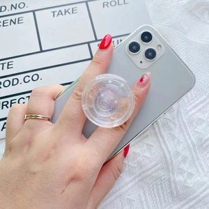 Close-up of a starry purple glitter phone grip with star sequins on a smartphone back