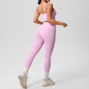 Rear view of pink sports set showing strappy crop top and high waist leggings