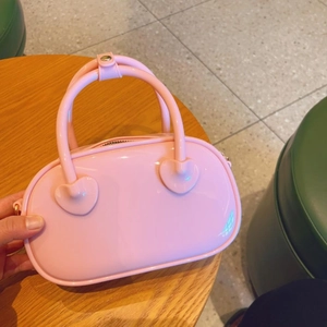 Detailed view of a pink PVC jelly bag in candy color on a wooden surface