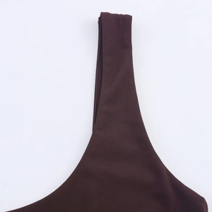 Macro detail of dark brown dress shoulder strap with smooth knit fabric and neat stitching