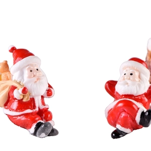 Charming ceramic Santa Claus figurines in sitting and lying poses with red festive suits