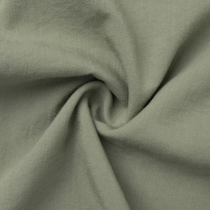 Detailed macro view of olive green linen fabric texture with a natural woven structure