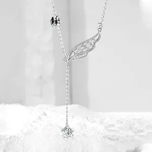 Macro shot of S925 sterling silver angel wing necklace with elegant tassel and zircon