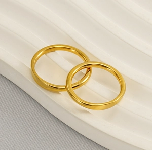 Minimalist 18k gold plated stainless steel plain band rings on white pedestal
