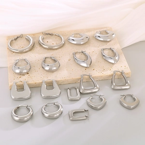 Polished geometric stainless steel earrings set on marble stone with a minimalist look