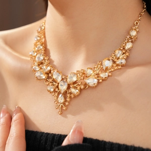 Close-up of luxury champagne water-drop crystal V-shaped necklace on a model